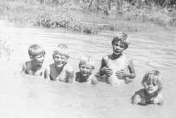 Martin swimming with brothers and sisters
